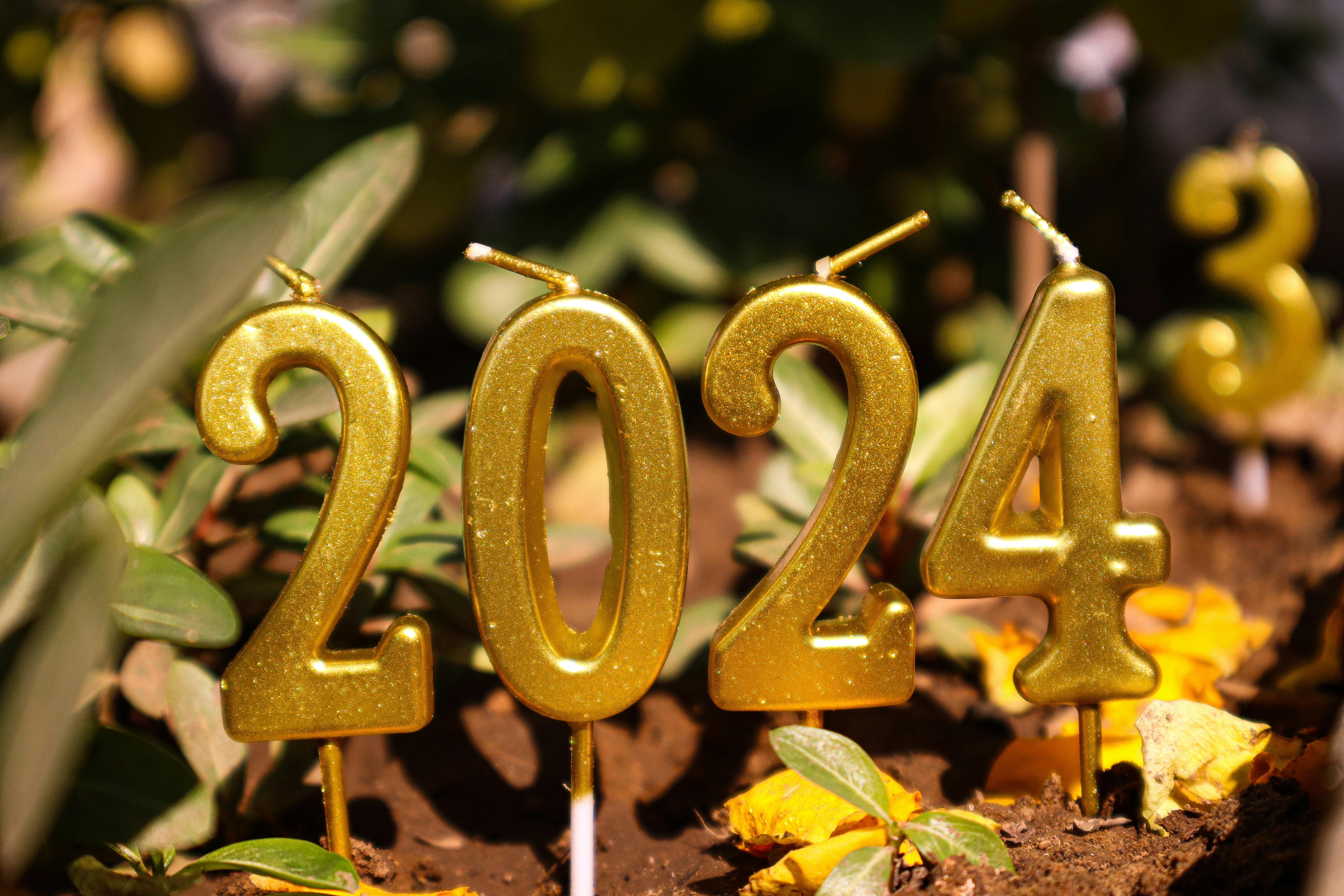 Golden 2024 candles in outdoor setting, perfect for New Year festivities.