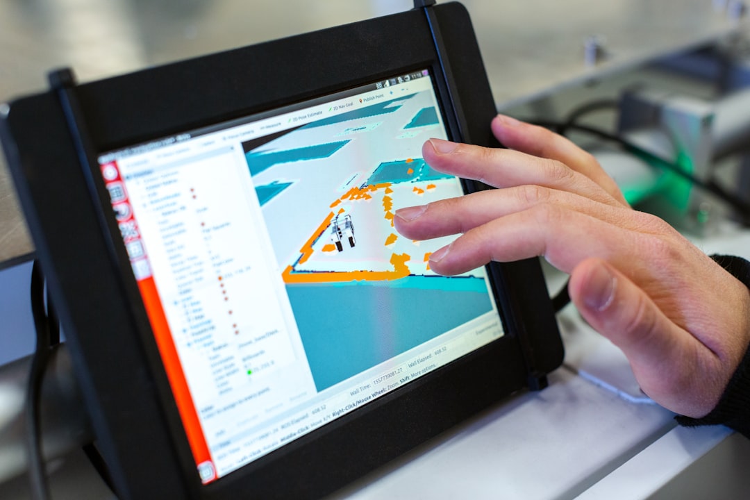 Device controlling agricultural robot | person holding black tablet computer
