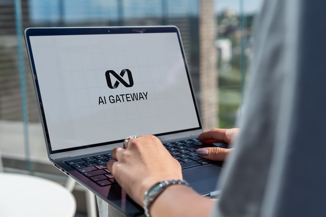 User working on a computer with AI technology software | Person typing on laptop with ai gateway logo.