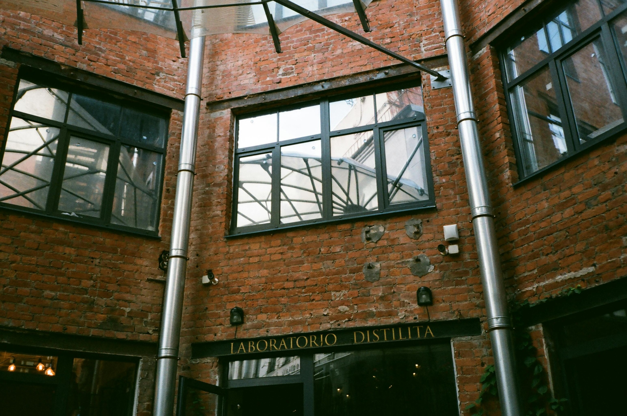 Exterior of brick residential building with big windows located in city in daytime